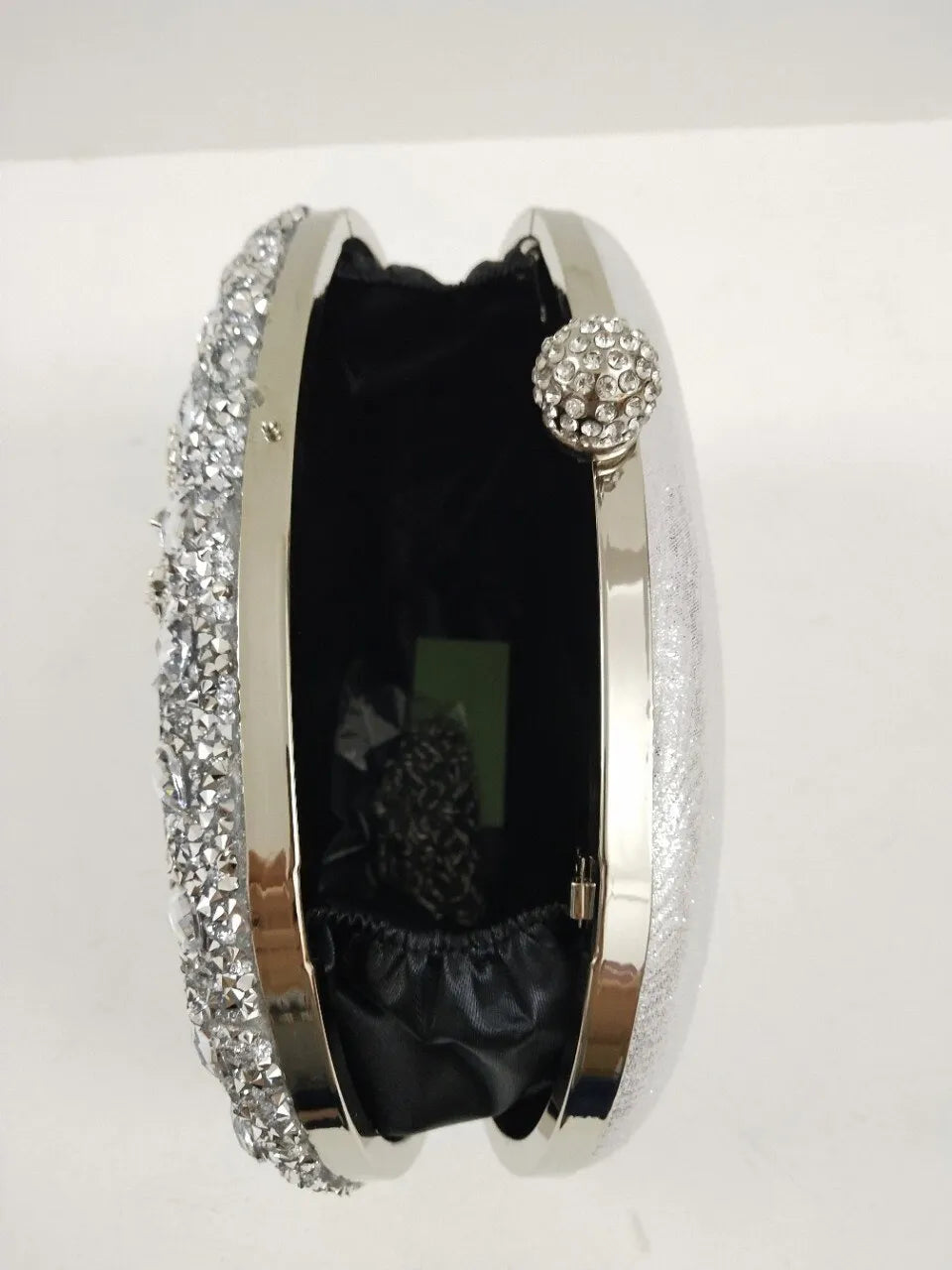 Inlaid with dazzling diamonds, it's the perfect accessory for any elegant evening affair